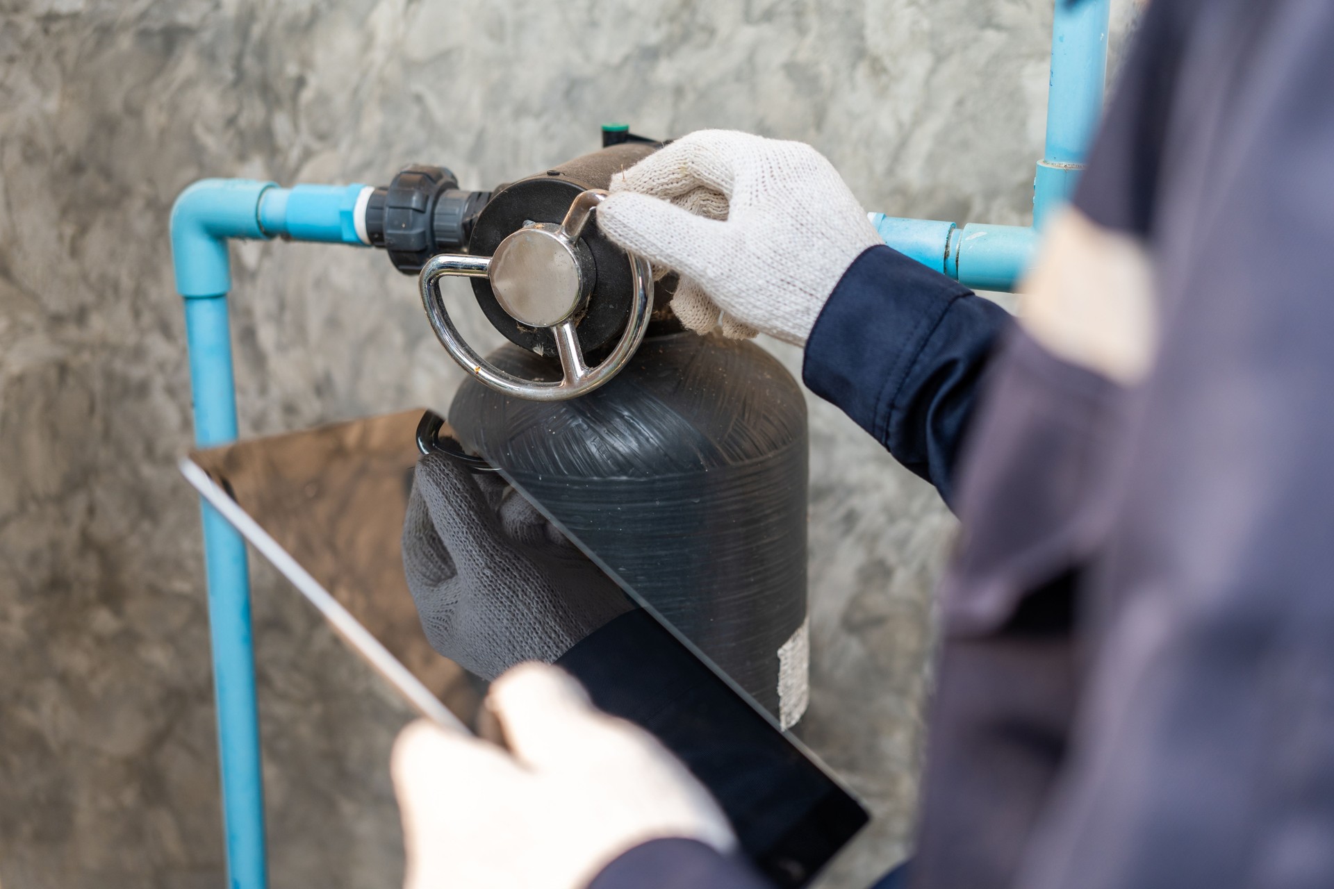 Male Plumber worker installation pipe system hand holding the water tap faucet. Plumbing checking service and repair.